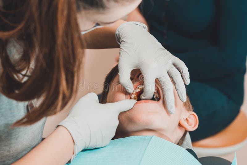 The Orthodontist Checks the Boy for a Bite of His Teeth Stock Image
