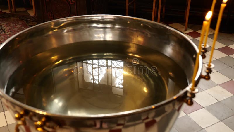 Orthodox baptism bowl of holy water with candles