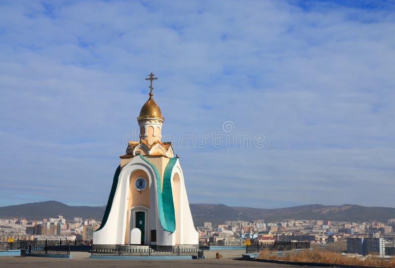 Orthodox chapel on the background of a big city