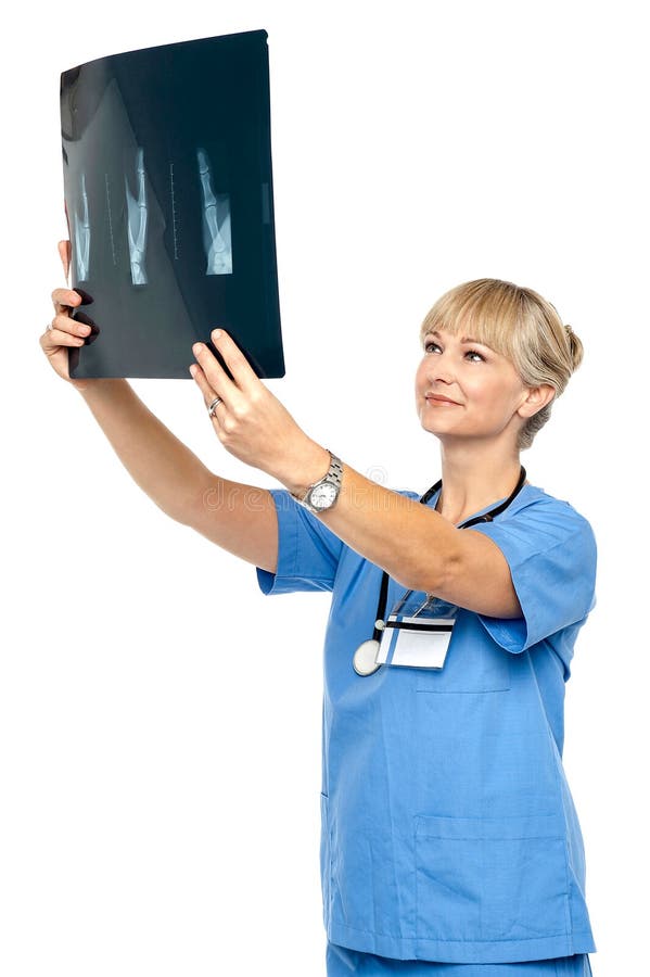 Orthopedic surgeon holding up x-ray to analyze royalty free stock image