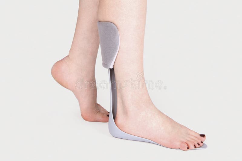 Orthopedic Ankle Brace. Medical Ankle Bandage. Medical Ankle Support Strap Adjustable Wrap Bandage Brace foot Pain Relief Sport. Leg Brace isolated on gray background. Orthopedic Ankle Brace. Medical Ankle Bandage. Medical Ankle Support Strap Adjustable Wrap Bandage Brace foot Pain Relief Sport. Leg Brace isolated on gray background