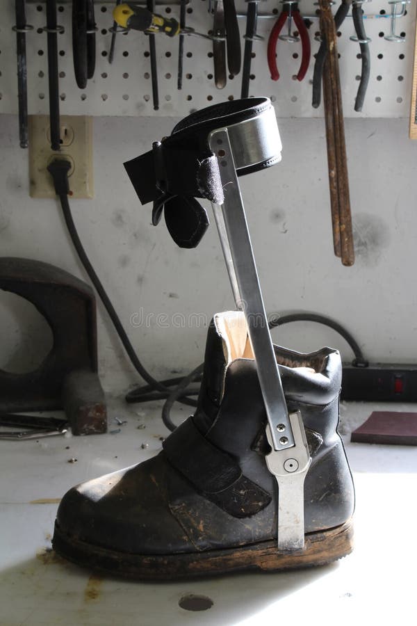 Orthotic Shoe with Attached Leg Brace on a Workbench Stock Image