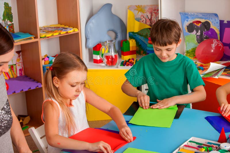 Os alunos com as tesouras nas crianças entregam o papel do corte imagens de stock Os alunos com as tesouras nas crianças entregam o papel do corte imagens de stock