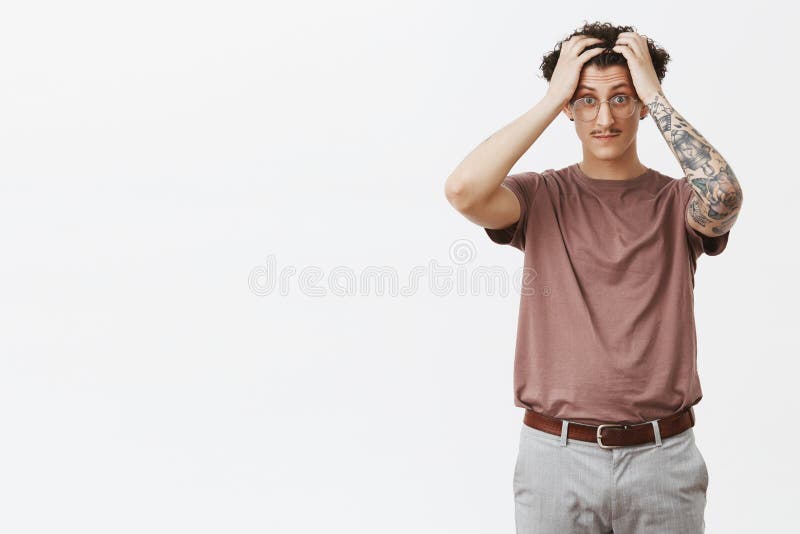 Os cérebros fervem dos estudantes estúpidos O retrato do incomodado e do chocado aturdiu o indivíduo encaracolado-de cabelo novo imagens de stock royalty free Os cérebros fervem dos estudantes estúpidos O retrato do incomodado e do chocado aturdiu o indivíduo encaracolado-de cabelo novo imagens de stock royalty free