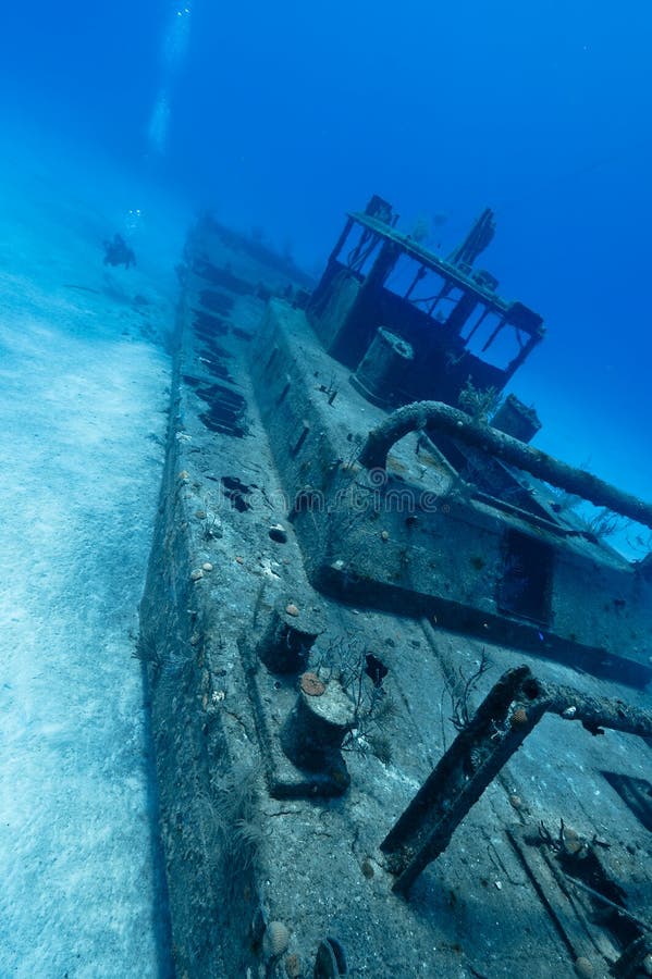 A diver explores the wreck of the Doc Poulsen, Grand Cayman island. A diver explores the wreck of the Doc Poulsen, Grand Cayman island.