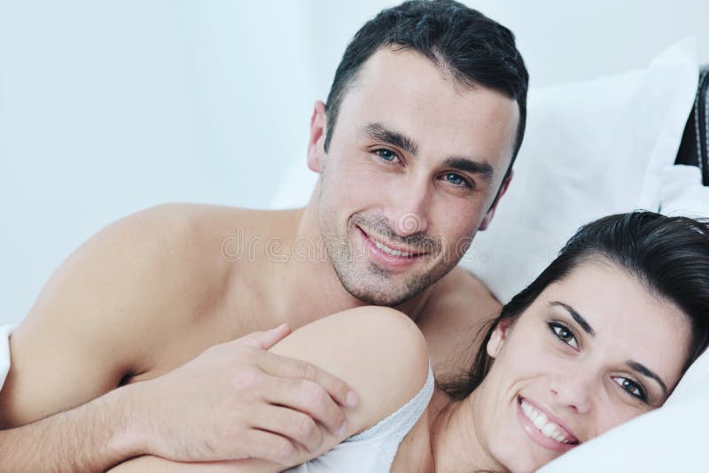 Os pares novos têm o bom tempo em seu quarto fotografia de stock Os pares novos têm o bom tempo em seu quarto fotografia de stock