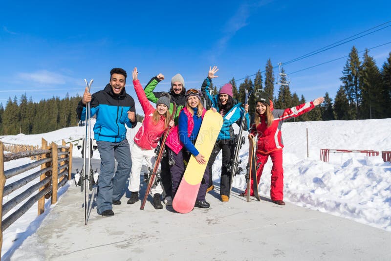 Os povos agrupam com Snowboard e mãos de ondulação alegres de Ski Resort Snow Winter Mountain fotos de stock royalty free Os povos agrupam com Snowboard e mãos de ondulação alegres de Ski Resort Snow Winter Mountain fotos de stock royalty free