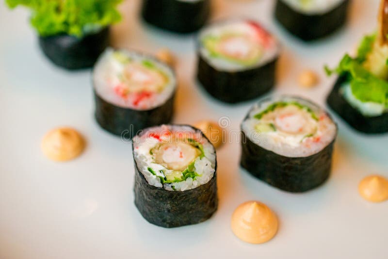 Os rolos de sushi frescos serviram na placa no restaurante foto de stock Os rolos de sushi frescos serviram na placa no restaurante foto de stock