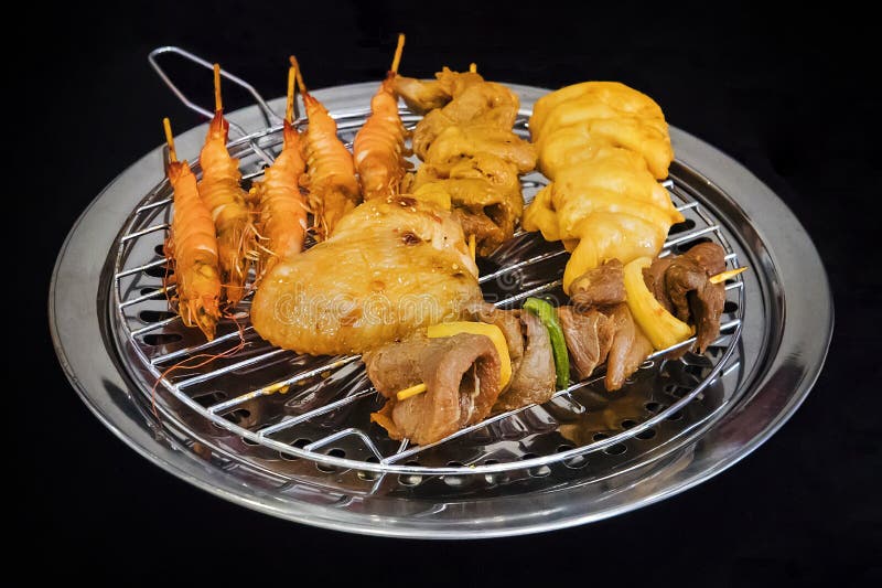 Os tipos diferentes de no espeto são fritados em uma grade elétrica segura na cozinha do restaurante Cozimento em casa Camar?o fr fotos de stock royalty free Os tipos diferentes de no espeto são fritados em uma grade elétrica segura na cozinha do restaurante Cozimento em casa Camar?o fr fotos de stock royalty free