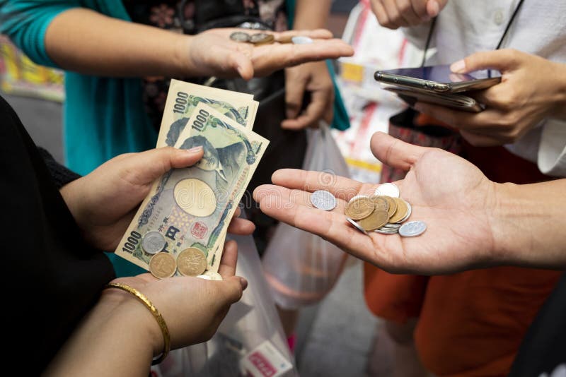 Osaka japan - november8,2018 :  unidentified people counting japanese yen coint and banknote in osaka city market. Osaka japan - november8,2018 :  unidentified people counting japanese yen coint and banknote in osaka city market