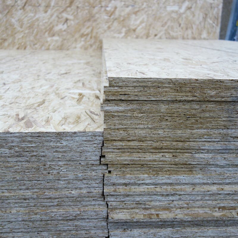 OSB background, dense, seamless surface. OSB sheets are stacked in a hardware store. Building material made from brown chips, sanded to a wood background. copy space