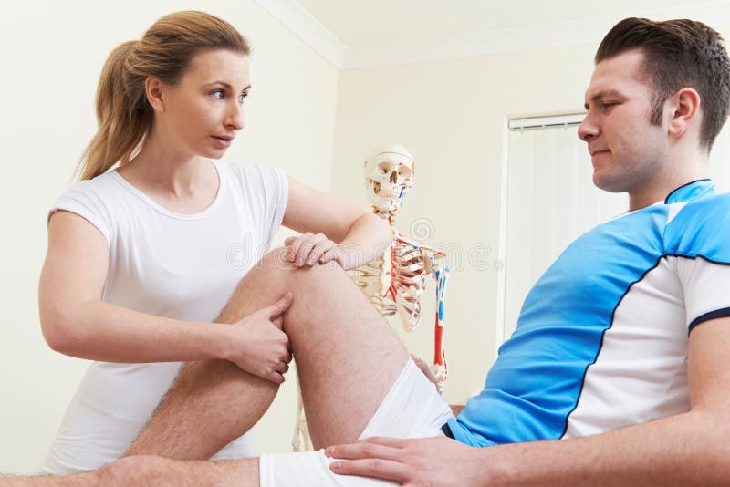 Osteopath Treating Man With Sports Injury. Osteopath Treating Man With Sports Injury