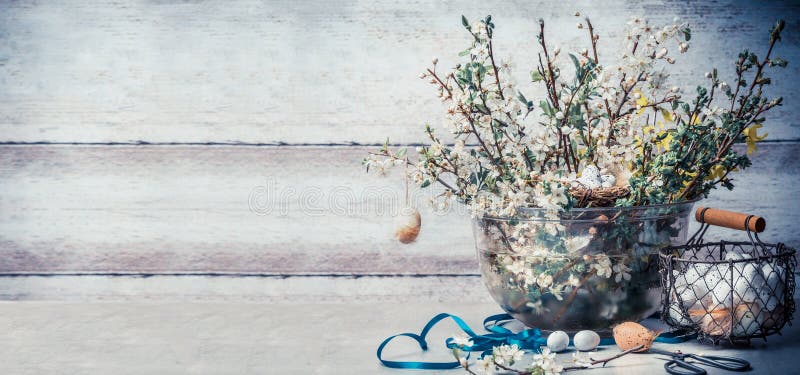 Ostern-Konzept mit Frühjahrdekorationseinstellung: Bündel des Frühlinges verzweigt sich mit Kirschblüte, Korb mit Eiern, Band stockbild Ostern-Konzept mit Frühjahrdekorationseinstellung: Bündel des Frühlinges verzweigt sich mit Kirschblüte, Korb mit Eiern, Band stockbild