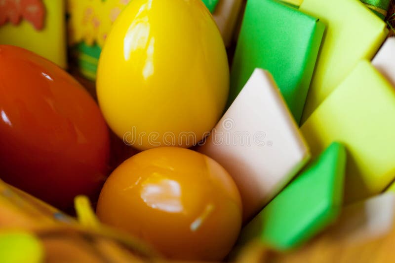 Ostern-Korb mit Eiern und eingewickelten Bonbons lizenzfreies stockbild Ostern-Korb mit Eiern und eingewickelten Bonbons lizenzfreies stockbild