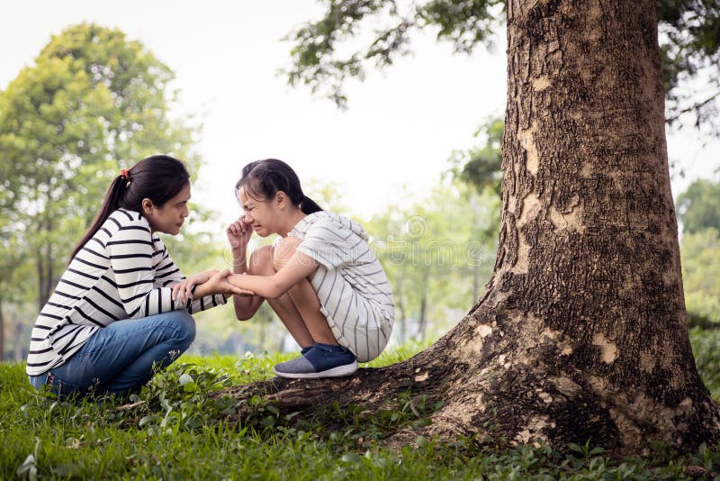 Stressed asian child girl sitting crying and thinking about problems at park,sad female teenage having psychological trouble with depressive symptoms feel despair,depression, sorrow,mental disorder. Stressed asian child girl sitting crying and thinking about problems at park,sad female teenage having psychological trouble with depressive symptoms feel despair,depression, sorrow,mental disorder