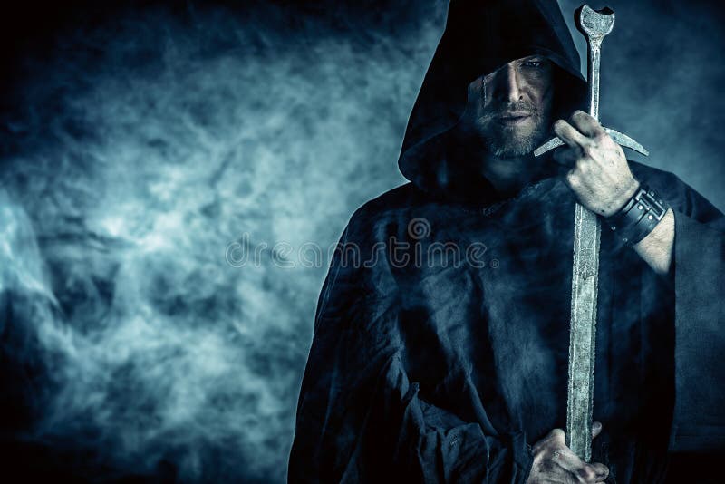 Portrait of a courageous warrior wanderer in a black cloak and sword in hand. Historical fantasy. Portrait of a courageous warrior wanderer in a black cloak and sword in hand. Historical fantasy.