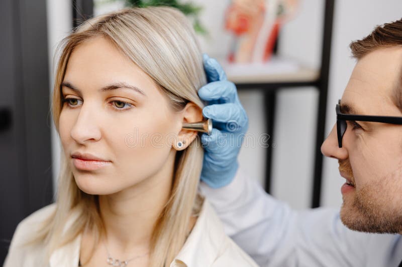 Otolaryngologist Doctor Checking Young Woman S Ear Using Otoscope Or