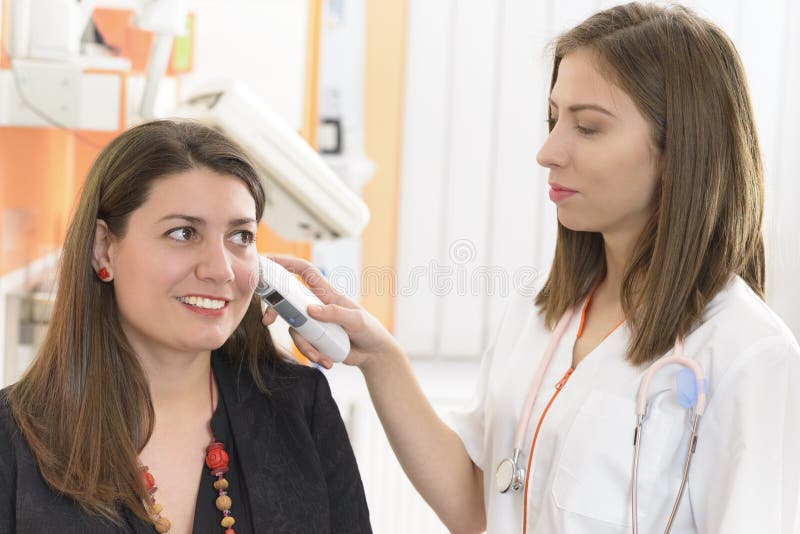 Otolaryngologist examining a woman ear