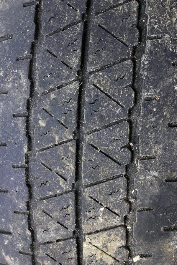 Very close view of the tread of an old used tire. Very close view of the tread of an old used tire.