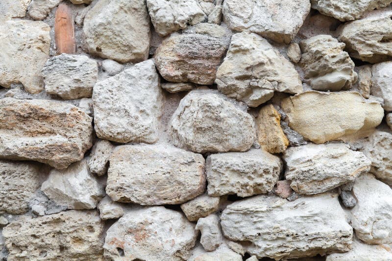 Oude grijze ruwe steenmuur Close-up stock afbeelding