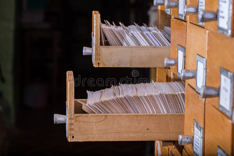 Old library or archive reference catalogue with opened card drawer. Database and knowledge catalog concept. Old library or archive reference catalogue with opened card drawer. Database and knowledge catalog concept