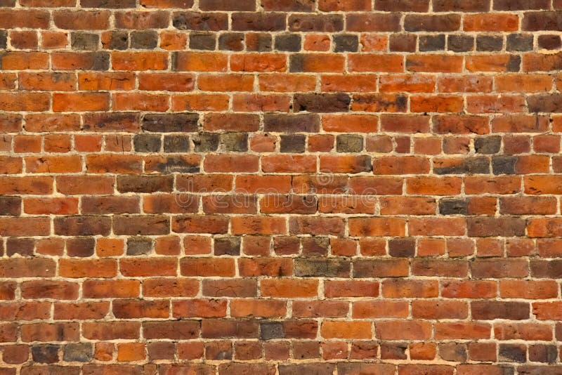 Abstract pattern of an old red, orange and black brick wall with lots of texture useful for backgrounds and wallpapers. Abstract pattern of an old red, orange and black brick wall with lots of texture useful for backgrounds and wallpapers.