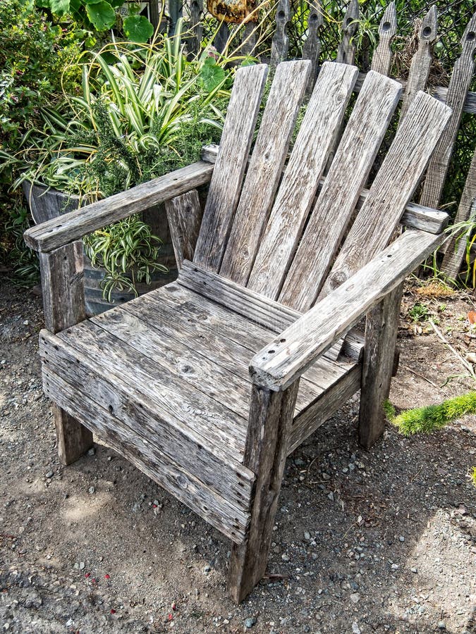 Inviting old wooden chair in a garden. Inviting old wooden chair in a garden