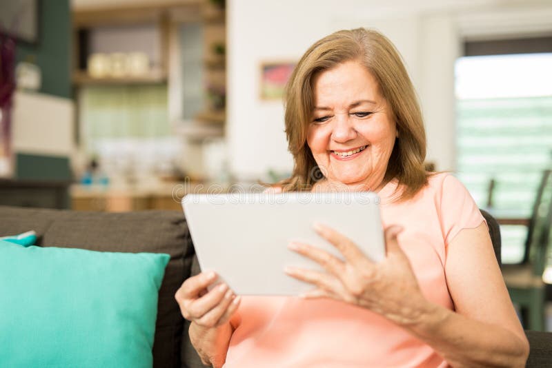Oudere vrouw die pret met technologie hebben stock afbeeldingen Oudere vrouw die pret met technologie hebben stock afbeeldingen