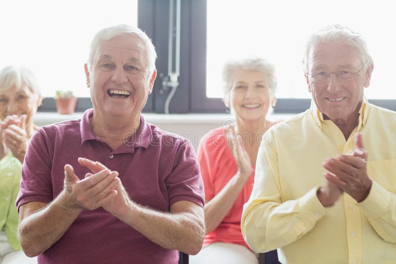Seniors clapping hands in a retirement home. Seniors clapping hands in a retirement home