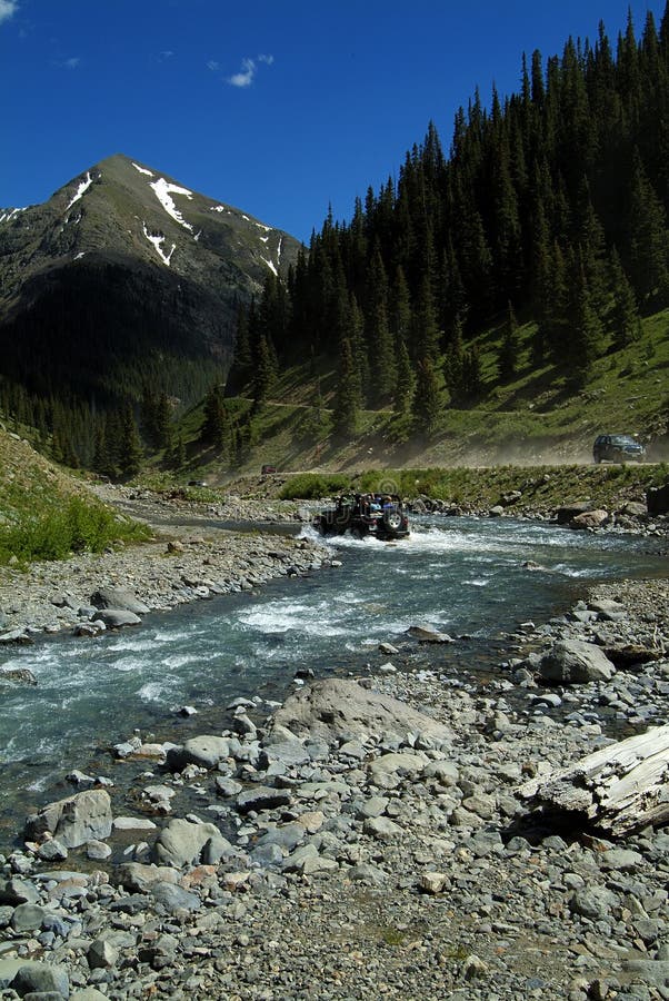 Jeep 4-wheeling through a mountain stream. Jeep 4-wheeling through a mountain stream