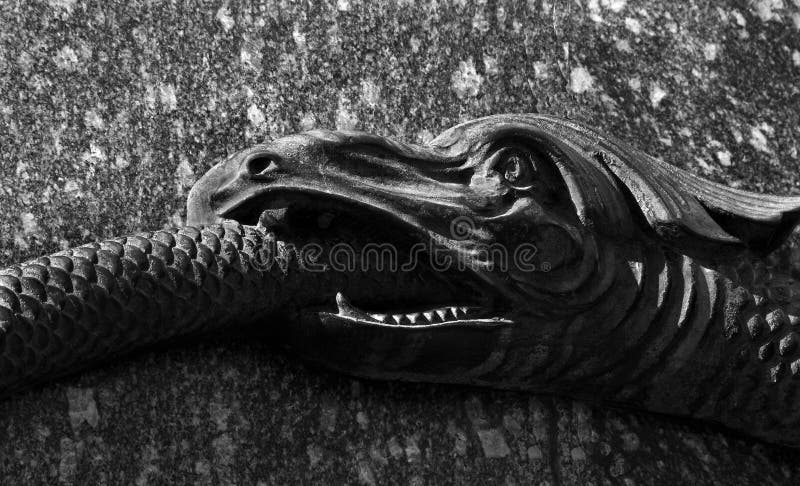 Ouroboros snake eating its own tail. a snake swallowing its tail. symbol of eternity and rebirth. fragment of the monument of Gl