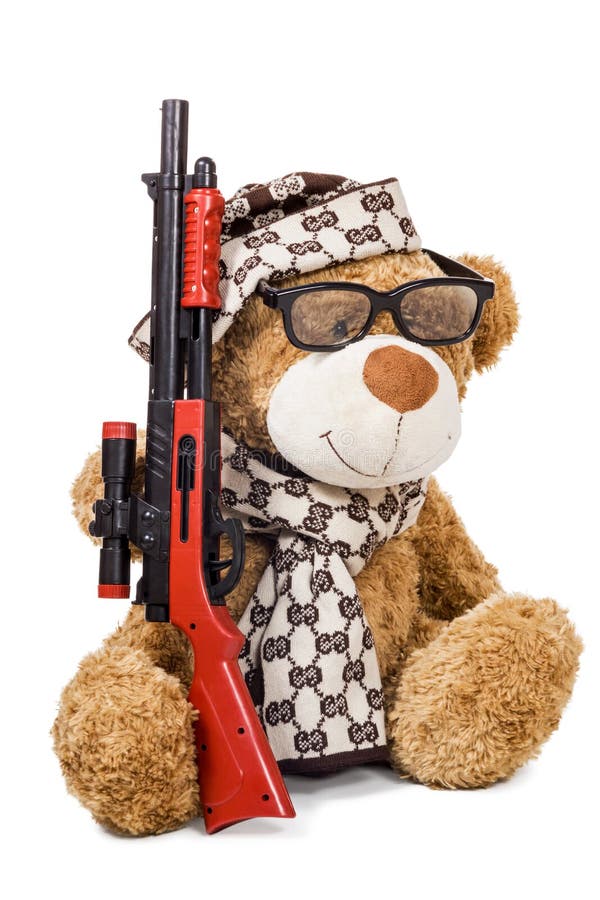 Ours de nounours dans le chapeau et l'écharpe avec le fusil images stock Ours de nounours dans le chapeau et l'écharpe avec le fusil images stock