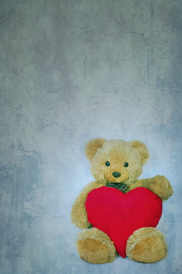 Ours de nounours de Brown avec le coeur mou sur le fond texturisé photographie stock libre de droits Ours de nounours de Brown avec le coeur mou sur le fond texturisé photographie stock libre de droits