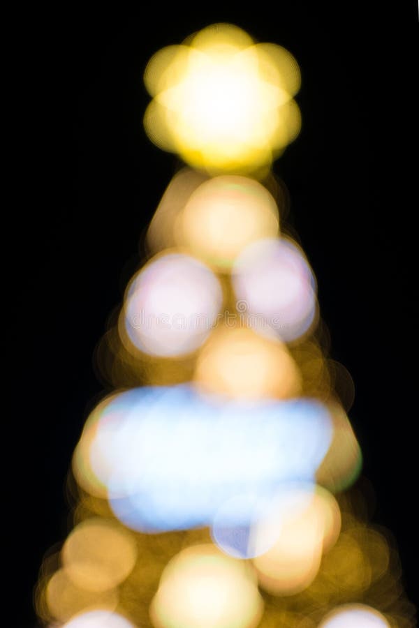 Out of Focus Christmas Tree with Yellow Lighting. Bokeh Light of