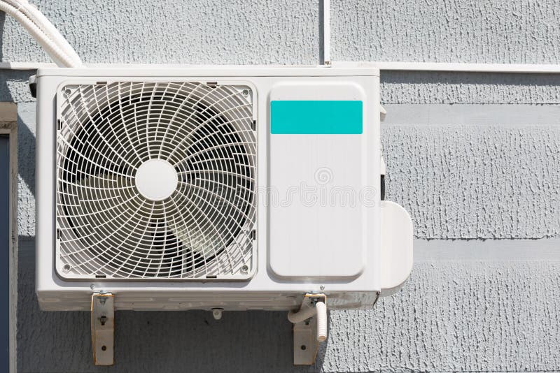 Outdoor Air Conditioner Unit on the Wall of a Building Stock Image