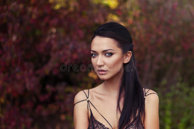 Outdoor atmospheric lifestyle photo of young beautiful lady. Black hair andgreen eyes. Warm autumn. Warm spring royalty free stock image Outdoor atmospheric lifestyle photo of young beautiful lady. Black hair andgreen eyes. Warm autumn. Warm spring royalty free stock image