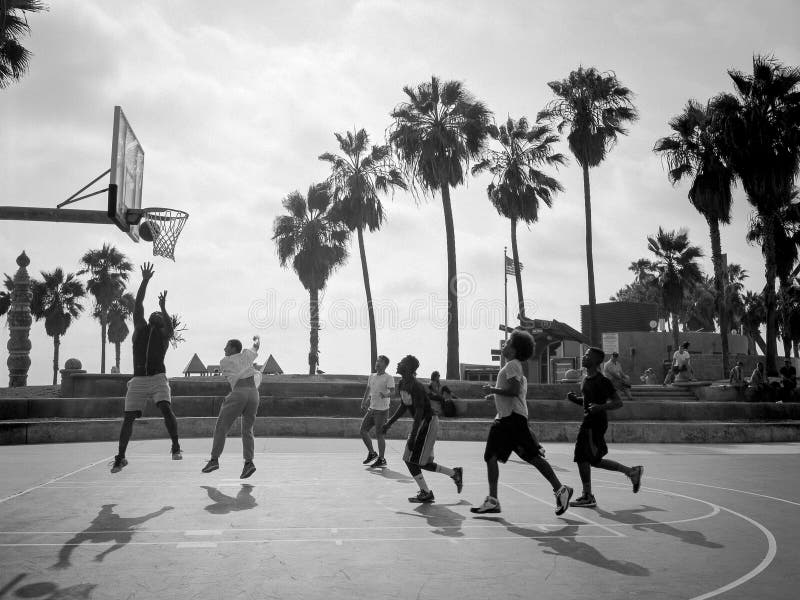 Group of teenagers playing basketball on the outdoor courts at venice beach in california. Group of teenagers playing basketball on the outdoor courts at venice beach in california