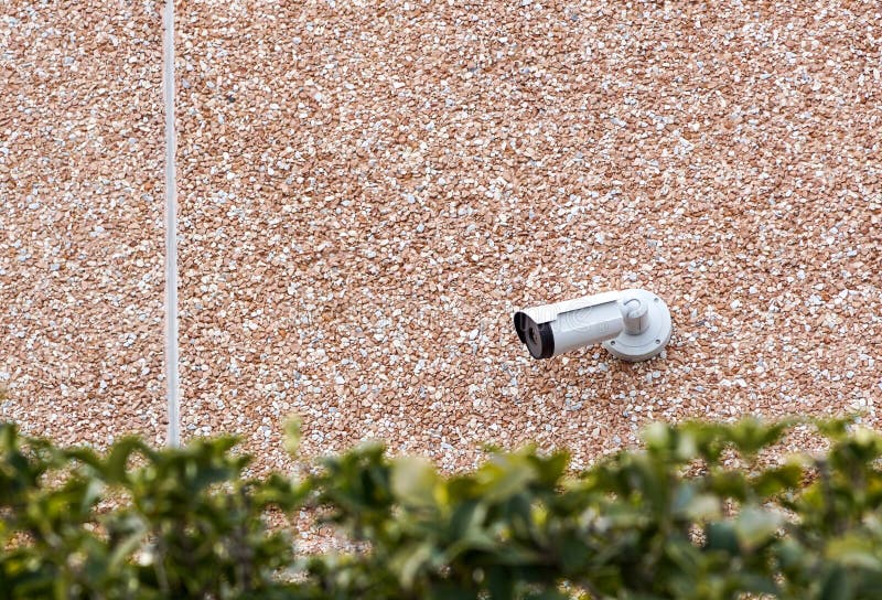 Outdoor bullet CCTV camera on the wall, space for text. Concept - technology and security