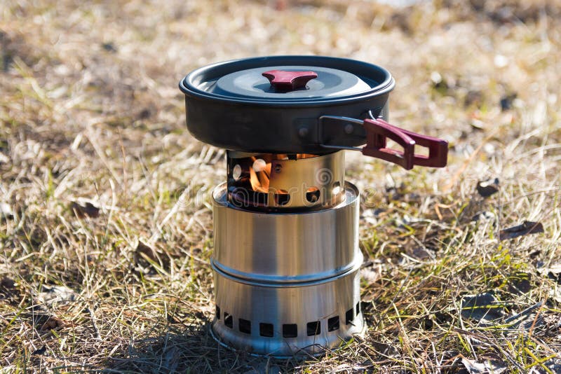 Outdoor Camping Cooking on Solid Wood Burner with Fire. Frying Pan with