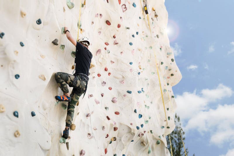 Outdoor climbing sport activity concept : Man climber on wall royalty free stock photo