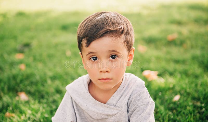 Outdoor close up portrait of adorable little boy