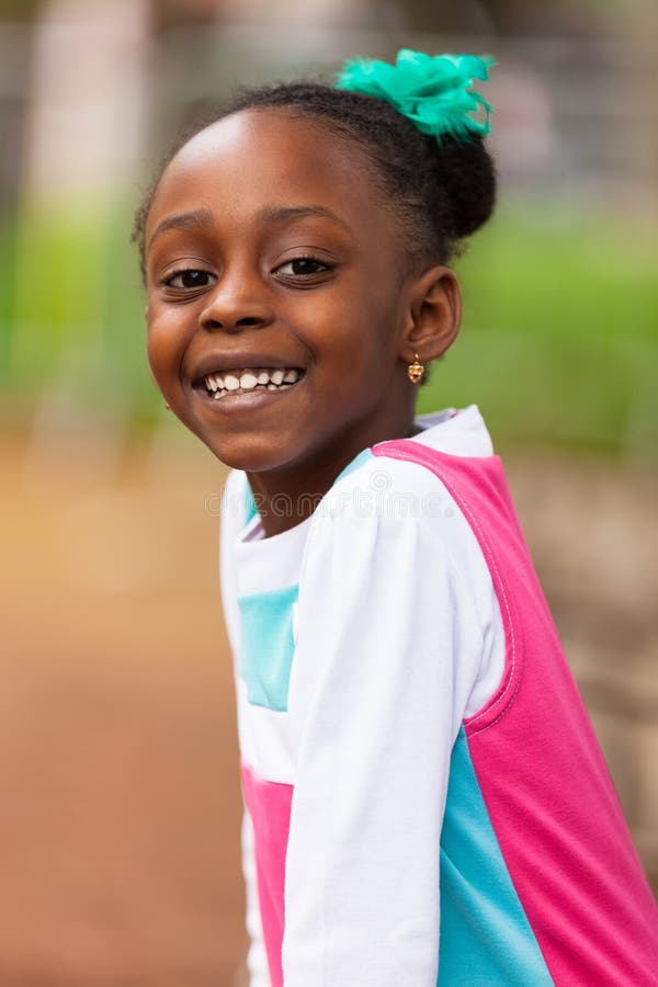 Outdoor close up portrait of a cute young black girl - African p stock image Outdoor close up portrait of a cute young black girl - African p stock image