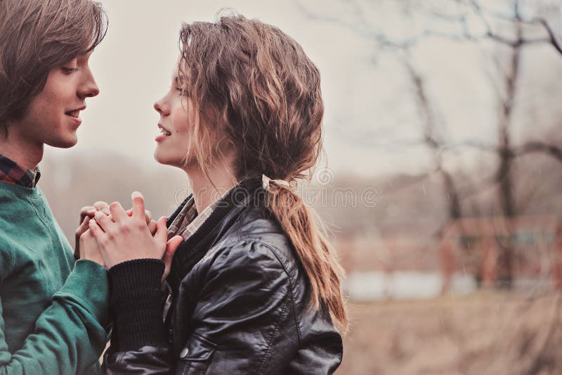 Outdoor close up portrait of young happy loving couple holding hands stock photo Outdoor close up portrait of young happy loving couple holding hands stock photo