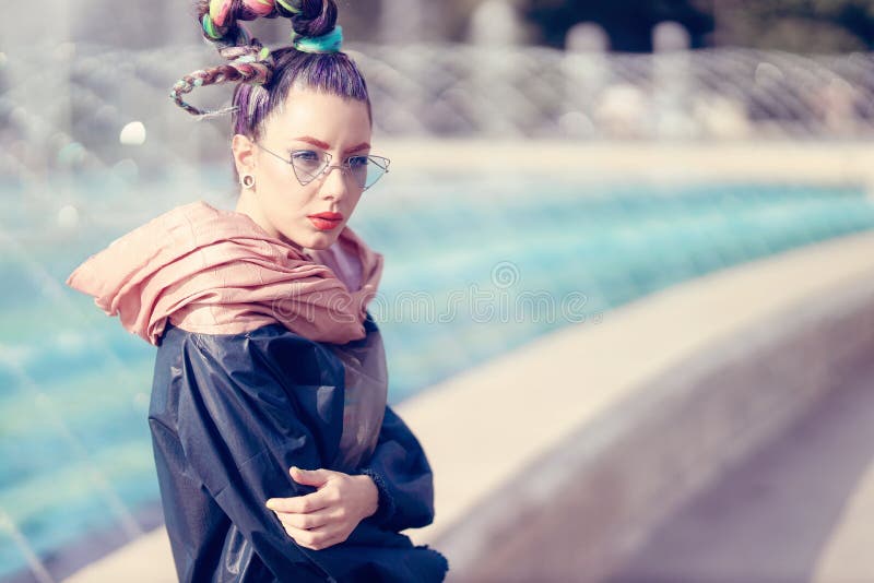 Outdoor close up portrait of a young lady with crazy look. Fashionable girl posing on street with artesian fountain. Model girl royalty free stock photography Outdoor close up portrait of a young lady with crazy look. Fashionable girl posing on street with artesian fountain. Model girl royalty free stock photography
