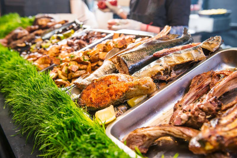 Outdoor Cuisine Culinary Buffet with healthy take away meal - grilled vegetables, fish and meat on the street food culinary market royalty free stock photo Outdoor Cuisine Culinary Buffet with healthy take away meal - grilled vegetables, fish and meat on the street food culinary market royalty free stock photo