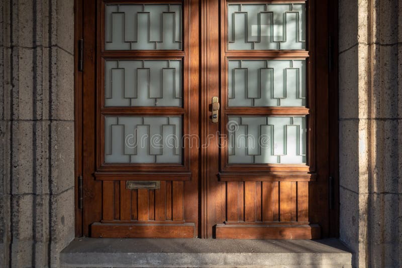 Wooden front doors with stone frame isolated on white background. Vector  cartoon set of house entrance, red, brown and yellow closed doors with  knobs and windows for building facade Stock Vector Image