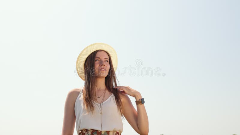 Outdoor fashion video of young beautiful lady in hat. Summer Beach travel.