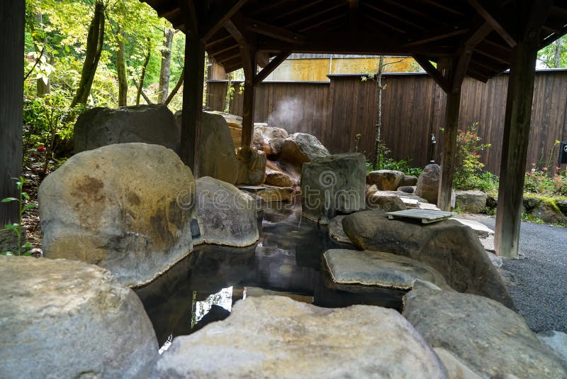 Outdoor feet hot spa with rock pool and wooden pillars roof, Kurokawa onsen