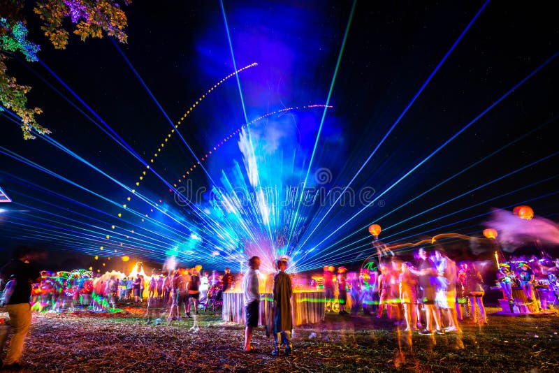 Outdoor night music party with laser lights and fire