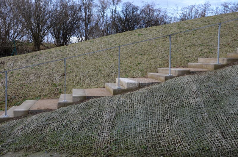 outdoor park stairs on a slope. jute mat protects against erosion. seed